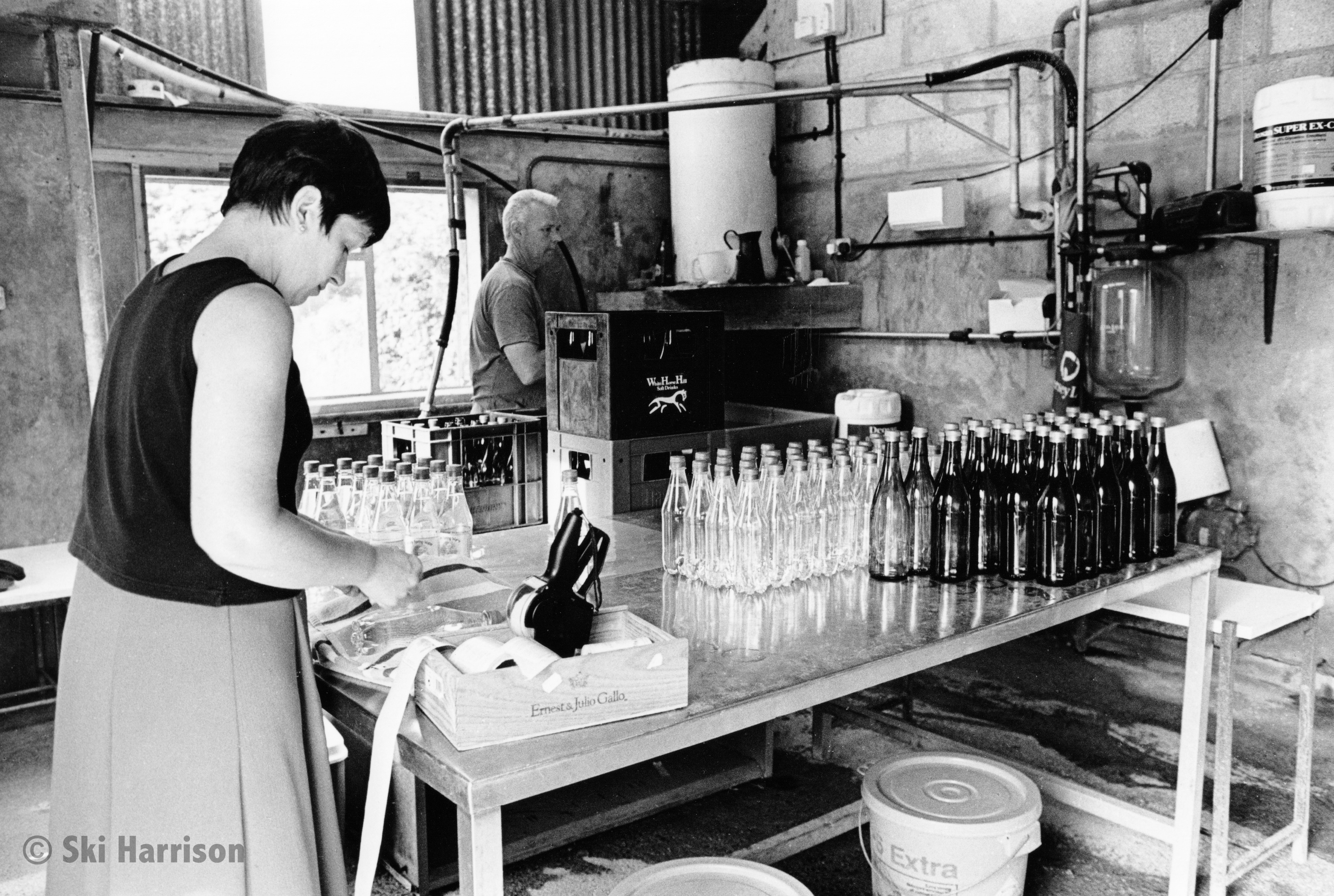 CS07 - Jane Geatches labelling bottles of Priory Spring Water with husband David, in the old milking parlour. Court Prior Farm, 2000