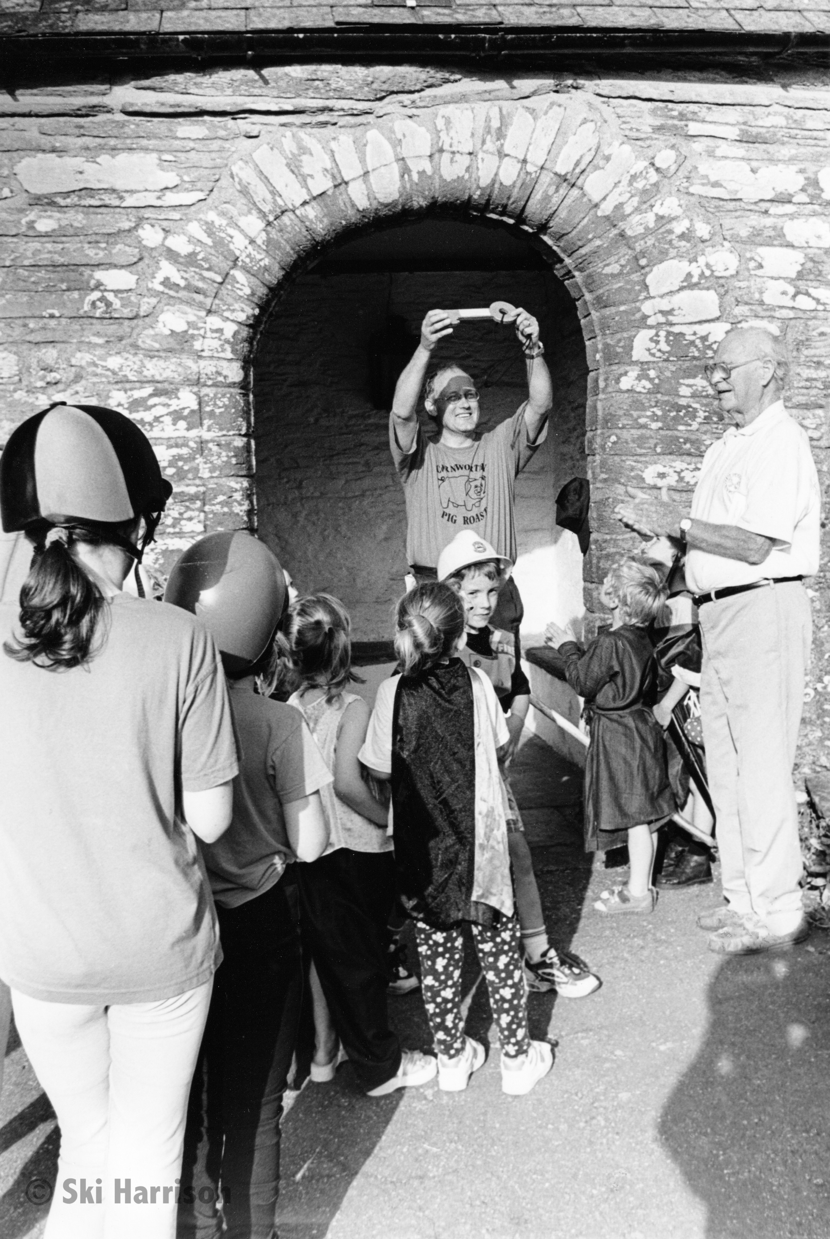 CS43 - Roly Richardson with children in fancy dress having handed the key of St Peter's to the Rev Richard King on completion of Beating the Bounds, 1998